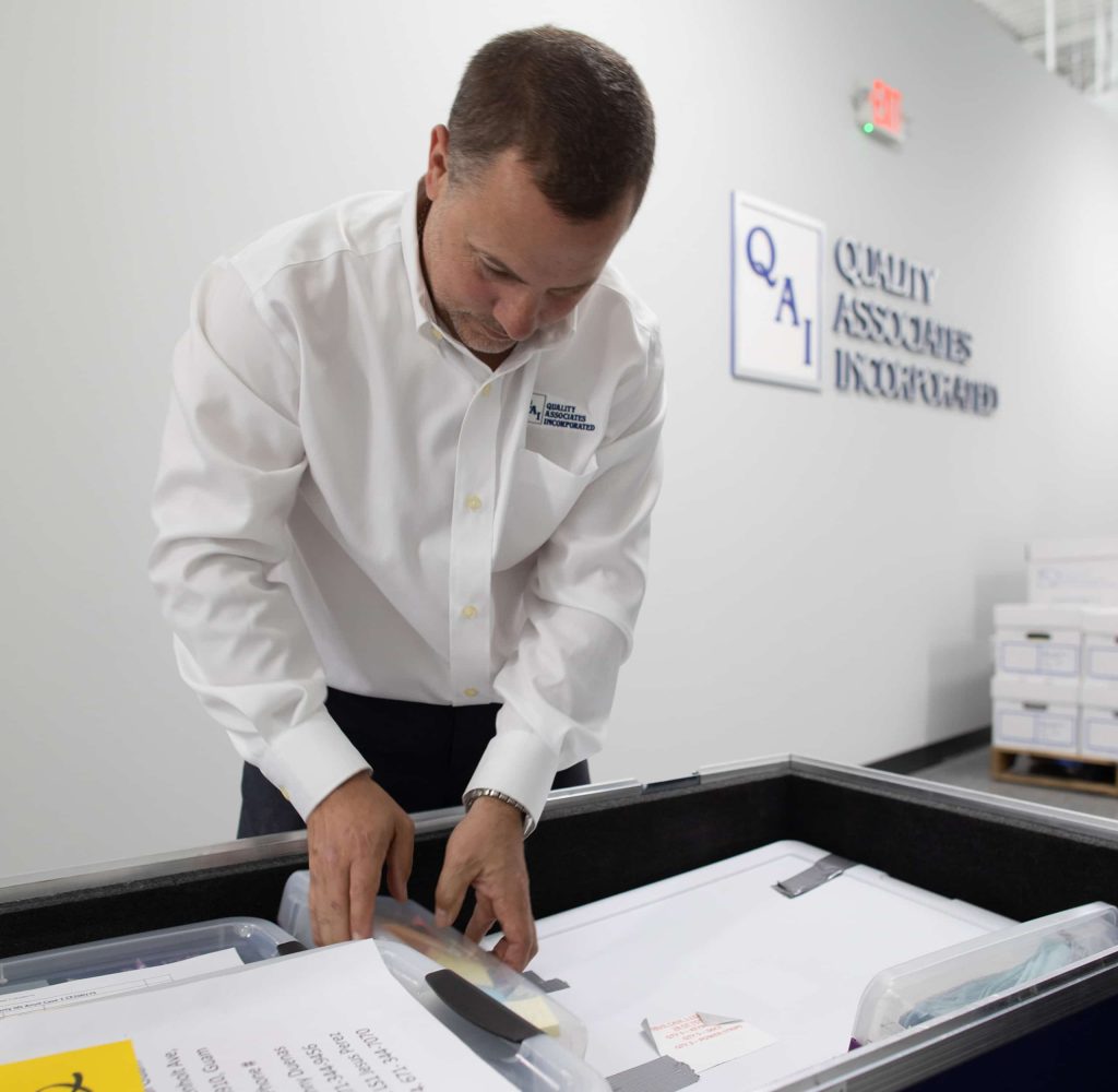 A QAI employee working with documents
