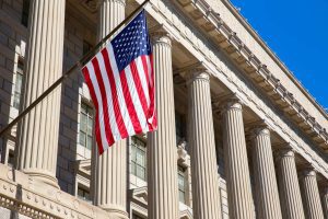 The American flag hanging outside a government building