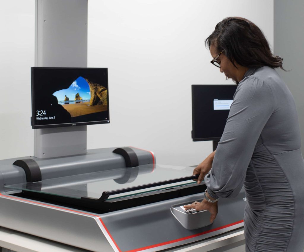 A QAI employee scanning a document