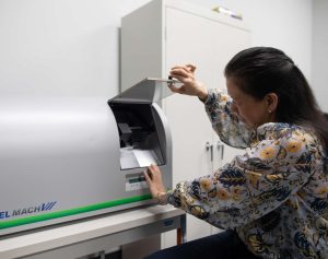 A QAI employee operating a piece of document conversion equipment